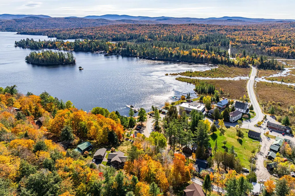 Raquette Lake's wooded islands and shoreline seen from above in fall